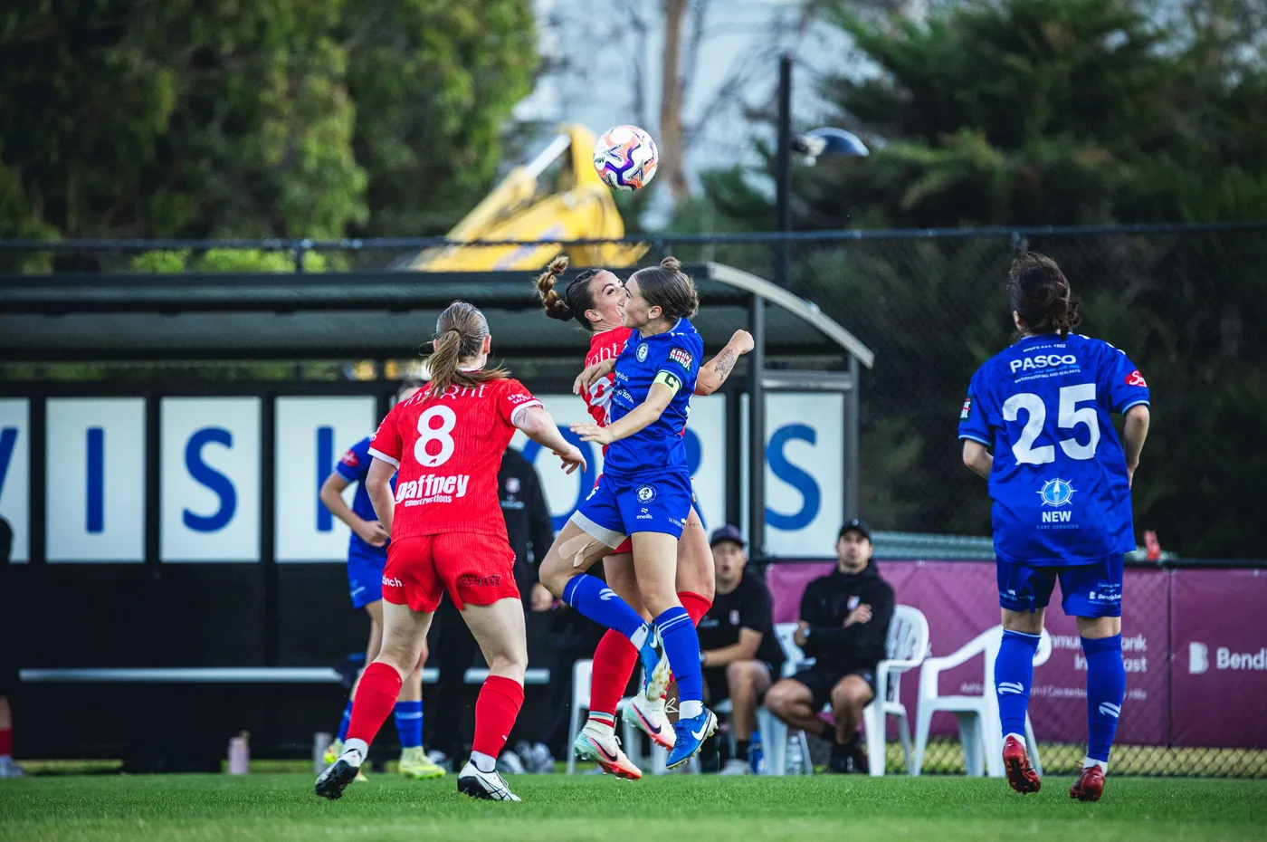 A Box Hill United player and an opponent rising together for a header