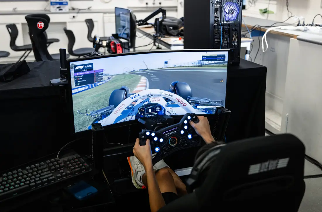 A driver at a racing simulator with a wide screen, from a Brighton Grammar shoot