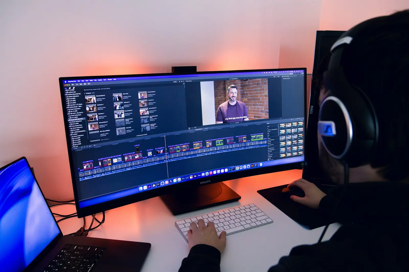 An editor at a wide monitor with a video edit timeline open